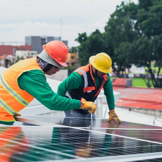 workers installing solar
